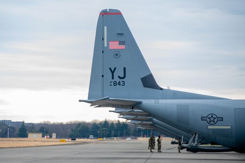 Members of the 374th Aircraft Maintenance Squadron (AMXS) perform final checks on C-130J Super Hercules.