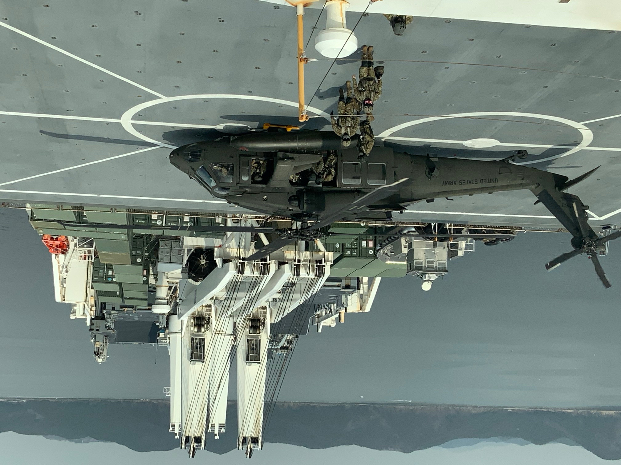 Soldiers with 2nd Battalion, 2nd Aviation Regiment, 2nd Combat Aviation Brigade exit a U.S. Army UH-60M Black Hawk helicopter after single-spot deck-landing qualifications on prepositioning ship USNS Dahl (T-AKR 312), March 7. (Courtesy photo)