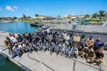 VICTORIA, Seychelles (March 5, 2024) Service members from partner nations participating in exercise Cutlass Express 2024 (CE 24) pose for a photo following Visit, Board, Search and Seizure (VBSS) training scenarios. Cutlass Express 2024, conducted by U.S. Naval Forces Africa and sponsored by U.S. Africa Command, increases the readiness of U.S. forces; enhances maritime domain awareness and collaboration among participating nations; and strengthens the capability of partner nations to combat piracy and counter illicit trafficking and illegal, unreported, and unregulated fishing. (U.S. Navy Photo by Chief Mass Communications Specialist Arif Patani)