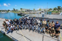 VICTORIA, Seychelles (March 5, 2024) Service members from partner nations participating in exercise Cutlass Express 2024 (CE 24) pose for a photo following Visit, Board, Search and Seizure (VBSS) training scenarios. Cutlass Express 2024, conducted by U.S. Naval Forces Africa and sponsored by U.S. Africa Command, increases the readiness of U.S. forces; enhances maritime domain awareness and collaboration among participating nations; and strengthens the capability of partner nations to combat piracy and counter illicit trafficking and illegal, unreported, and unregulated fishing. (U.S. Navy Photo by Chief Mass Communications Specialist Arif Patani)