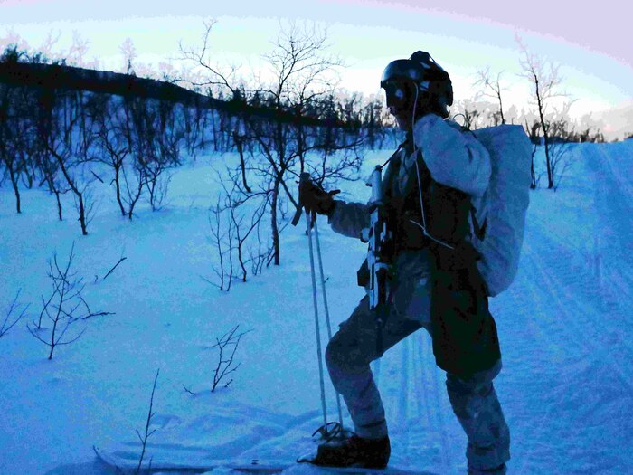 An Airman looks through night vision goggles.