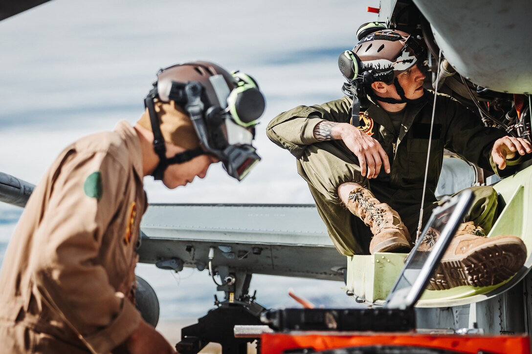 U.S. Marine Corps Cpl. Austin Potter, a Roosevelt, Utah native, right, and Sgt. Ivandominick Uy, a Manila, Philippines native, both AH-1Z Viper mechanics with Marine Light Attack Helicopter Squadron (HMLA) 267, Marine Aircraft Group 39, 3D Marine Aircraft Wing, conduct maintenance on a Viper in support of a Marine Air-Ground Task Force Warfighting Exercise during Service Level Training Exercise 2-24 at Camp Wilson, Marine Corps Air-Ground Combat Center, Twentynine Palms, California, Feb. 19, 2024. MWX is the culminating event for SLTE 2-24 that improves U.S. and allied service members’ operational capabilities and lethality as a MAGTF. (U.S. Marine Corps photo by Lance Cpl. Richard PerezGarcia)