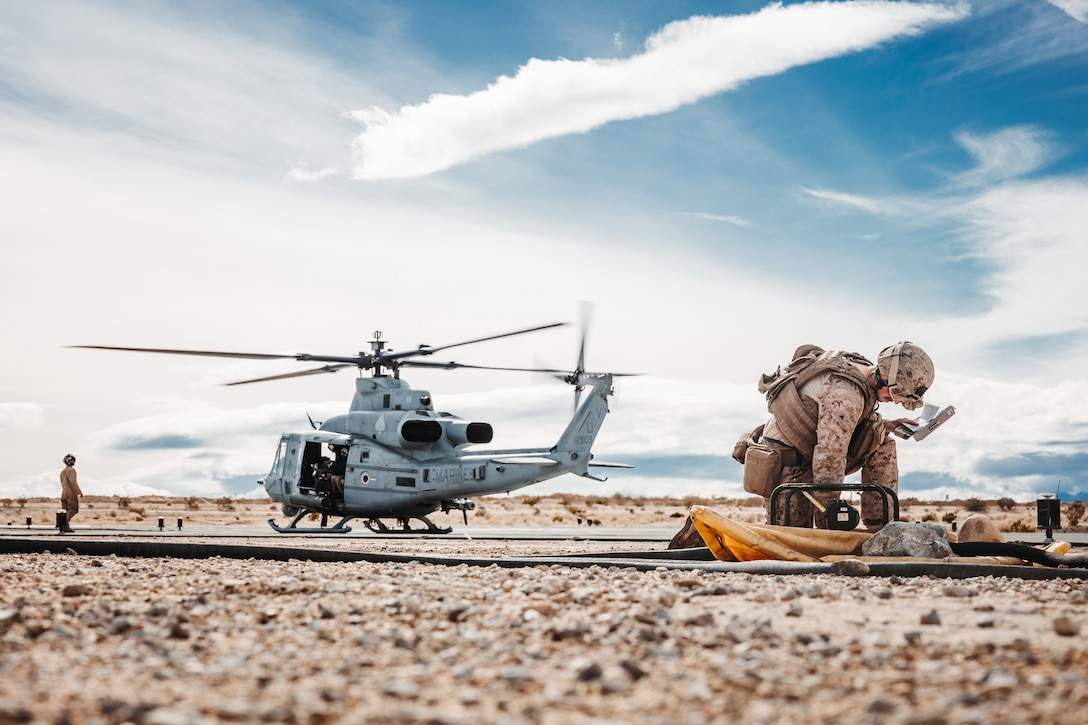 U.S. Marine Corps Lance Cpl. Kaleb Dillard, a Tacoma, Washington native, bulk fuel specialist with Marine Wing Support Squadron 271, Marine Aircraft Group 14, 2nd Marine Aircraft Wing, annotates fuel levels during a Marine Air-Ground Task Force Warfighting Exercise as part of Service Level Training Exercise 2-24 at Camp Wilson, Marine Corps Air-Ground Combat Center, Twentynine Palms, California, Feb. 19, 2024. MWX is the culminating event for SLTE 2-24 that improves U.S. and allied service members’ operational capabilities and lethality as a MAGTF. (U.S. Marine Corps photo by Lance Cpl. Richard PerezGarcia)