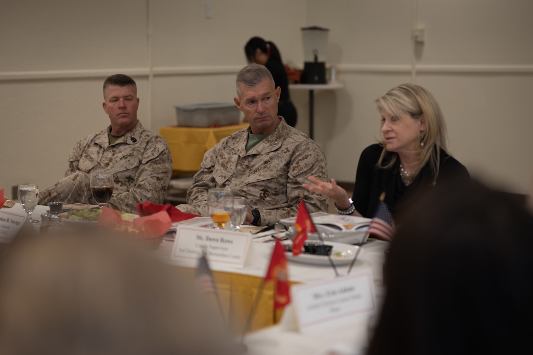 U.S. Marine Corps Maj. Gen. Thomas B. Savage, commanding general of Marine Air-Ground Task Force Training Command, Marine Corps Air-Ground Combat Center, center, listens to Dawn Rowe, a Los Angeles, California native, county supervisor of San Bernardino County 3rd District, right, during an annual Community Leaders Luncheon at MCAGCC, Twentynine Palms, California, Feb. 8, 2024. The luncheon is an annual event hosted by The Combat Center’s commanding general for local senior officials who provide resources and services to The Combat Center that often partner directly with installation functions. (U.S. Marine Corps photo by Lance Cpl. Iris Gantt)