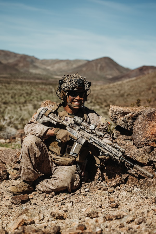 U.S. Marine Corps Lance Cpl. Koby Syhavong, an Olathe, Kansas native, squad leader with Charlie Company, 1st Battalion, 4th Marine Regiment, 1st Marine Division, poses for a photo during a Marine Air-Ground Task Force Distributed Maneuver Exercise as part of Service Level Training Exercise 2-24 at Marine Corps Air-Ground Combat Center, Twentynine Palms, California, Feb. 15, 2024. MDMX is designed to test the MAGTF’s operational capabilities in austere, multi-domain, offensive and defensive operations against adversaries at a regimental level. (U.S. Marine Corps photo by Lance Cpl. Justin J. Marty)