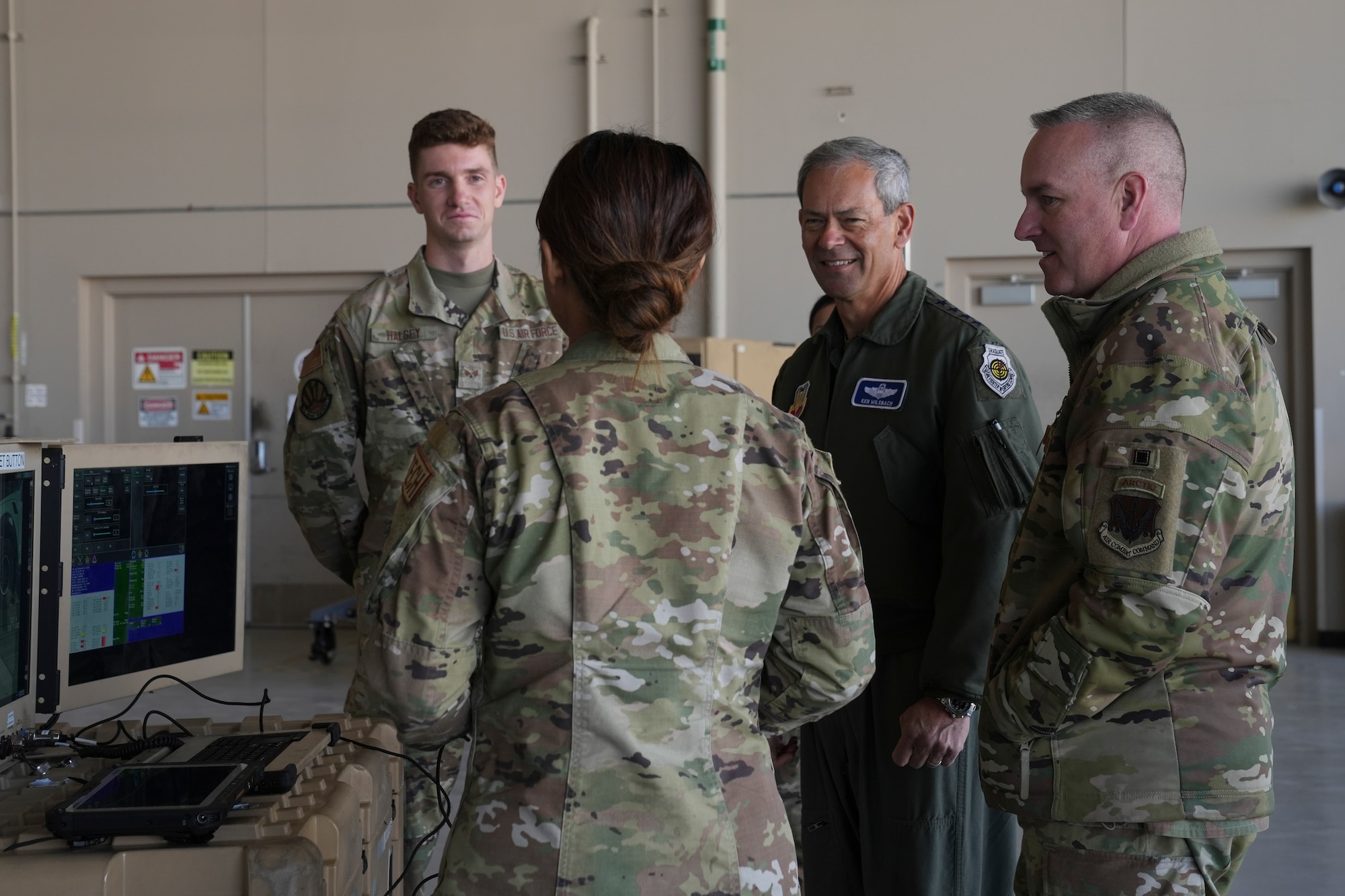 An airman explains military equipment to fellow airmen.