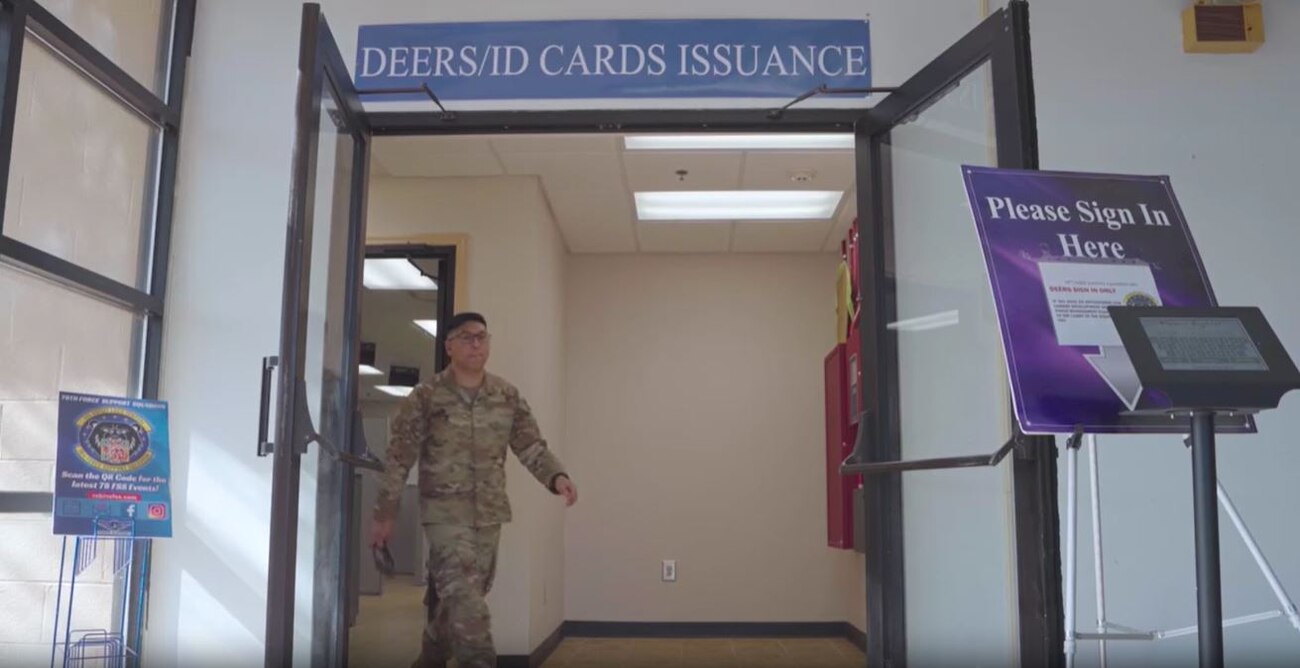 Man in military uniform walking outside of a room