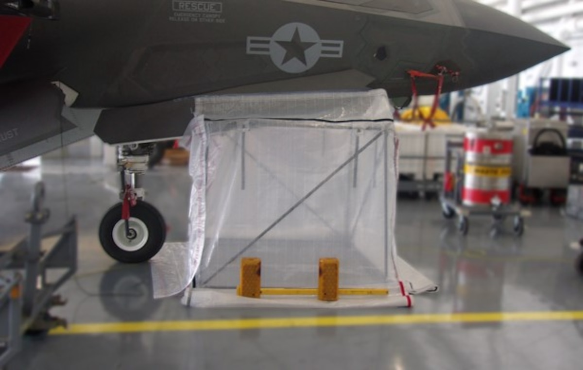 A DIRT Bag 6090 maintainer fabricated enclosure kit, or MFEK, is set up for an on-aircraft demonstration of a structural repair in a hangar at a Marine Corps Air Station facility in July 2022. A MFEK is a pre-fabricated walk-in enclosure that rapidly enables maintainers to perform sustainment on the Air Force’s current fleet of combat aircraft in a controlled, dust- and debris-free environment that works the same way for every maintainer, every time. The enclosure is comprised of durable, transparent panels and a lightweight, reconfigurable frame made of telescoping poles, and is scalable and reconfigurable from 54” up to 90”. AFWERX, the DAF’s innovation arm and a functional directorate within the Air Force Research Laboratory, or AFRL, funded the design, development and successful flightline testing of Cornerstone Research Group’s DIRT Bag DB-6090, which will be sold alongside the smaller DIRT Bag DB-2424 model previously developed under an AFRL Small Business Innovation Research program. (U.S. Air Force photo)