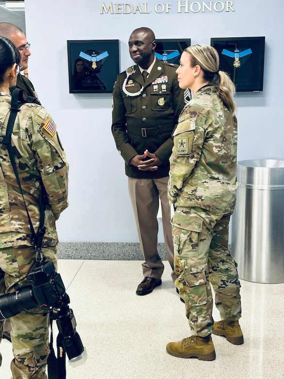 Two women in U.S. Army OCP Uniforms stand with two men in U.S. Army AGSU Uniforms.