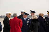 General officers ifrom various branches are talking with women, who are dressed in winter coats.