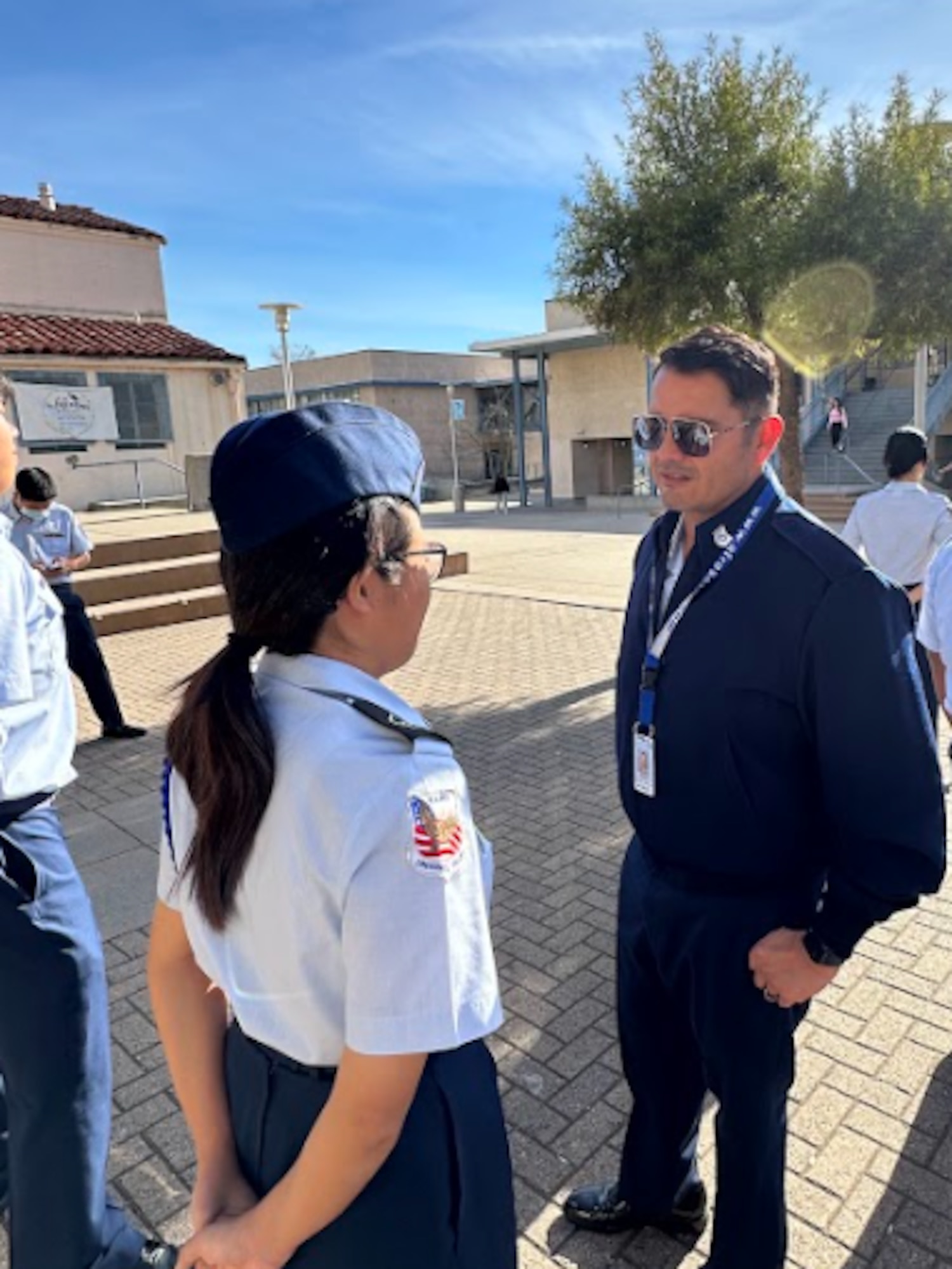 Retired Technical Sgt. Mariano Morua, right, inspects a Crescenta Valley High School Air Force Junior ROTC cadets.