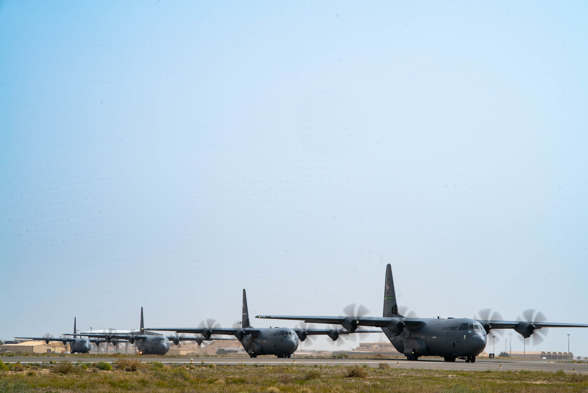 Four C-130Js loaded with humanitarian aid bound for airdrop over Gaza taxi from an undisclosed location.