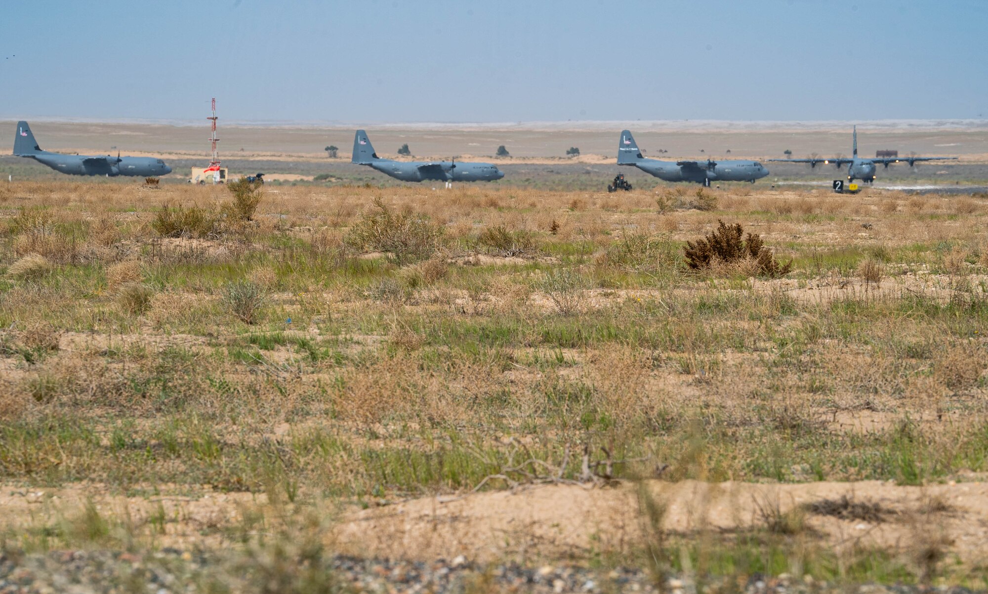 Four C-130J aircraft loaded with humanitarian aid bound for airdrop over Gaza.