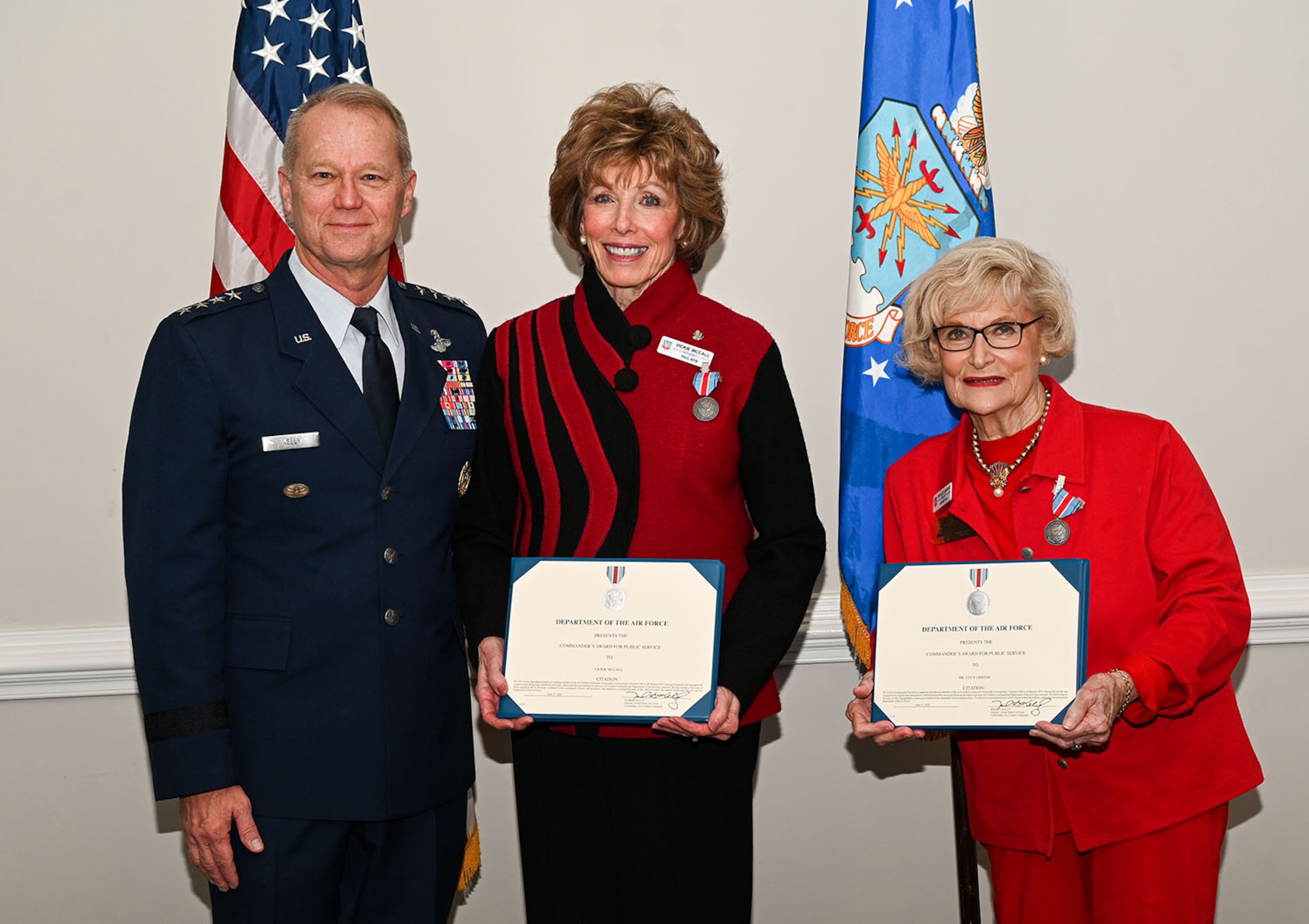 Gen. Mark Kelly stands with Vickie McCall (center) and Dr. Lucy Greene (right) Air Combat Command Commander’s Group members
