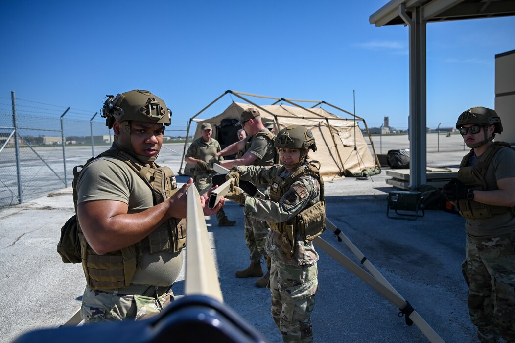 Members of the 433rd Contingency Response Flight prepare to set up a tent at a training campsite during a training event at Joint Base San Antonio-Lackland, Texas on Mar. 2, 2024.