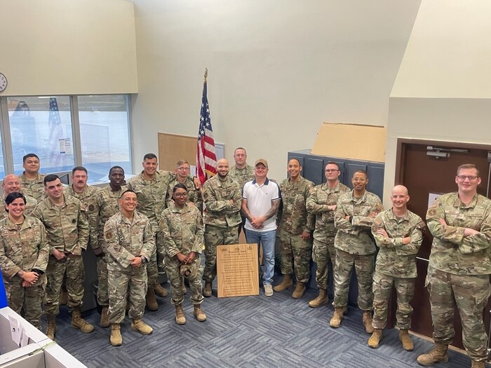 Airmen stand and pose for a group photo