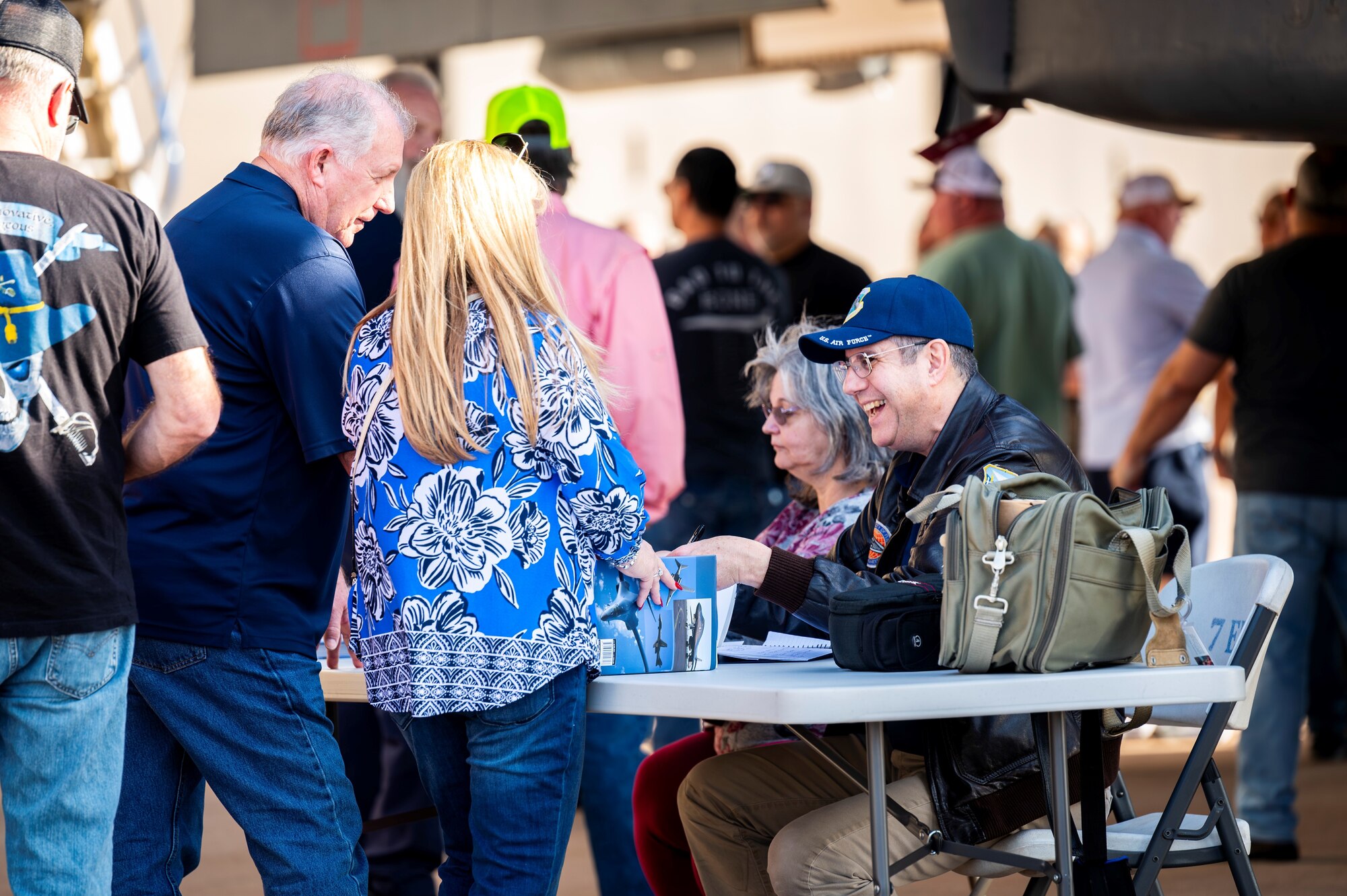 Kenneth P. Katz, author, signs books for retired U.S. Air Force maintainers and their families during a maintainer reunion at Dyess Air Force Base, Texas, Feb. 24, 2024. More than 50 former maintainers attended the reunion to share their wisdom and experience with active-duty pilots and maintenance Airmen. (U.S. Air Force photo by Senior Airman Leon Redfern)