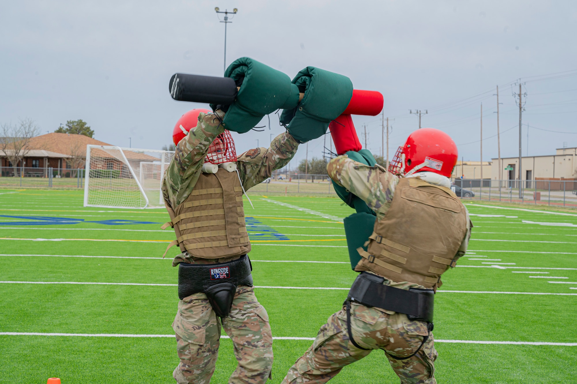 Dyess Airmen perform fighting techniques with pugil sticks during the Marine Corps Martial Arts Program class at Dyess Air Force Base, Texas, Feb. 27, 2024. During the course,  members endured tough and realistic training, to ensure a ready force and enhance combat readiness. The program, developed by the U.S. Marine Corps in 2001, uses an advancement system similar to most martial arts programs which includes tan, grey, green, brown and black belts. (U.S. Air Force photo by Airman 1st Class Alondra Cristobal Hernandez)