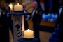Lit candles sit above U.S. Air Force enlisted ranks during a Chief Recognition Ceremony Misawa Air Base, Japan, March 9, 2024.
