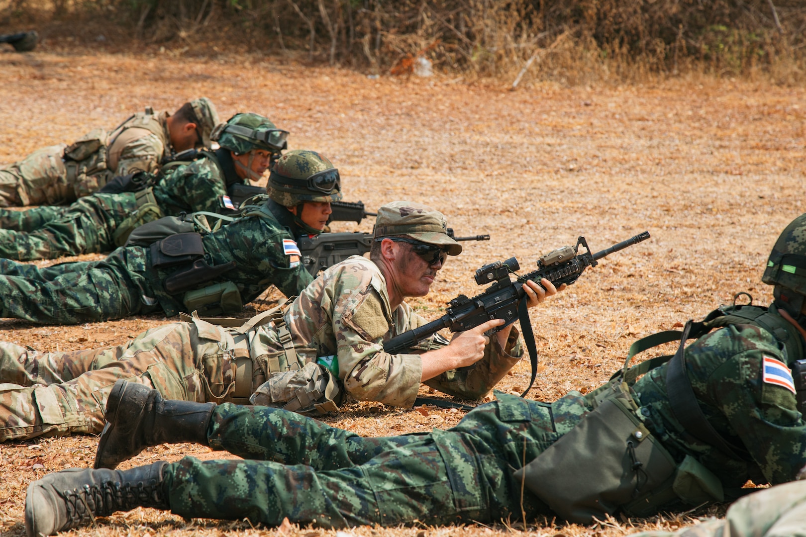U.S. Army soldiers assigned to Chosin Company, 1st Battalion, 17th Infantry Regiment, 2nd Stryker Brigade Combat Team, 7th Infantry Division, and members of the 1st Company, 1st Battalion, 2nd Infantry Regiment Royal Thai Army conduct squad movement techniques at a small arms range during Exercise Cobra Gold 24, Feb. 29, 2024, in Sa Kaeo Province, Thailand. The multilateral exercise strengthens regional relationships and enhances interoperability among Allies and partners through shared experiences and rigorous training.  (U.S. Army photo by Staff Sgt. Effie Mahugh, 7th Infantry Division)