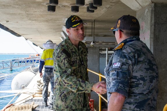 ROCKINGHAM, Western Australia (March 10, 2024) – U. S. Navy Cmdr. James Tuthill, commanding officer of the Los Angeles-class fast-attack submarine USS Annapolis (SSN 760), greets Royal Australian Navy Capt. Ken Burleigh, commanding officer of HMAS Stirling, after Annapolis moors alongside Diamantina Pier at Fleet Base West in Rockingham, Western Australia, March 10, 2024. The nuclear-powered, conventionally-armed submarine is in HMAS Stirling for the second visit by a fast-attack submarine to Australia since the announcement of the AUKUS (Australia, United Kingdom, United States) Optimal Pathway in March 2023. (U.S. Navy photo by Mass Communication Specialist 2nd Class Kaitlyn E. Eads)