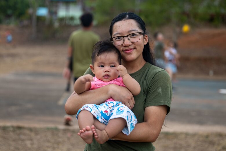 U.S. Marine Corps Cpl. Katie Lee, a supply chain and materiel management specialist with Marine Wing Support Squadron (MWSS) 171, Marine Aircraft Group 12, and native of New York, holds a local child from the Ban Prakaet Village in Chanthaburi, Thailand, Feb. 21, 2024. Marines of MWSS-171 lent their engineering expertise to multilateral humanitarian efforts during Cobra Gold 24. Joint Exercise Cobra Gold is the largest joint exercise in mainland Asia and a concrete example of the strong alliance and strategic relationship between Thailand and the United States. This year is the 43rd iteration of the multilateral exercise and is held from Feb. 27 to March 8, 2024. (U.S. Marine Corps photo by Cpl. Calah Thompson)