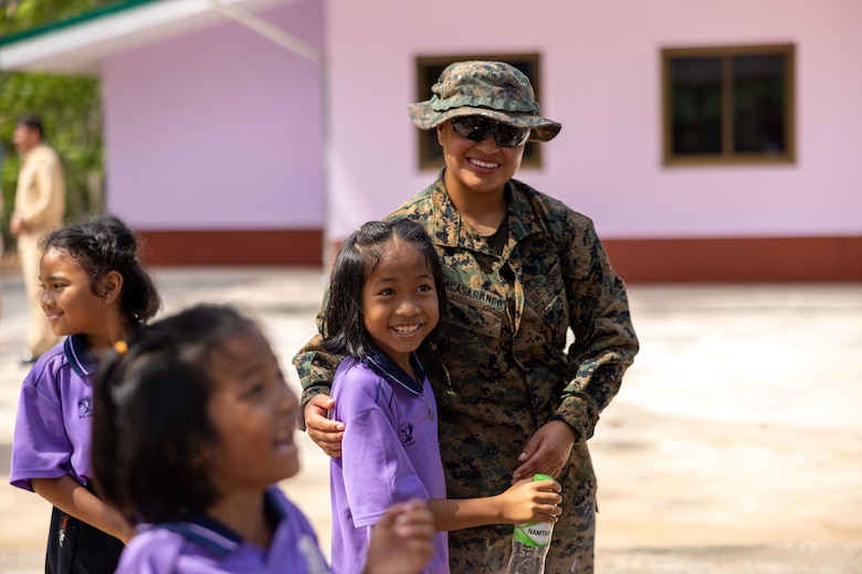 U.S. Marine Corps Cpl. Janina Sacasarango, a motor transport operator with Marine Wing Support Squadron (MWSS) 171, Marine Aircraft Group 12, a native of New York, hugs a student from the Ban Prakaet school in Chanthaburi, Thailand, Mar. 3, 2024. Marines of MWSS-171 lent their engineering expertise to multilateral humanitarian efforts during Cobra Gold 24. Joint Exercise Cobra Gold is the largest joint exercise in mainland Asia and a concrete example of the strong alliance and strategic relationship between Thailand and the United States. This year will be the 43rd iteration of the multilateral exercise and will be held from Feb. 27 to March 8, 2024. (U.S. Marine Corps photo by Cpl. Calah Thompson)