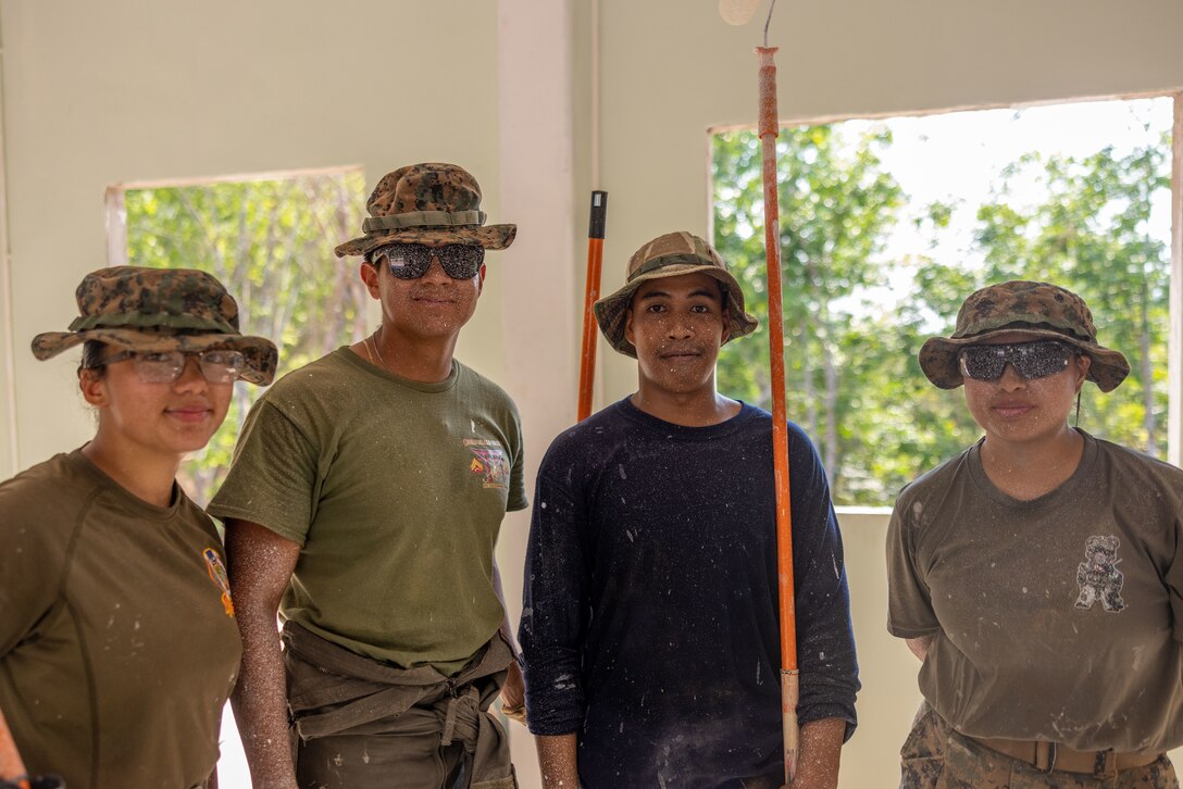U.S. Marines with Marine Wing Support Squadron (MWSS) 171, Marine Aircraft Group 12, and a Royal Thai marine with the Royal Thai Marine Corps Construction Company of Combat Engineers pose for a photo together while painting at the Ban Prakaet School in Chanthaburi, Thailand, Feb. 21, 2024. Marines of MWSS-171 lent their engineering expertise to multilateral humanitarian efforts during Cobra Gold 24. Joint Exercise Cobra Gold is the largest joint exercise in mainland Asia and a concrete example of the strong alliance and strategic relationship between Thailand and the United States. This year is the 43rd iteration of the multilateral exercise, held from Feb. 27 to March 8, 2024. (U.S. Marine Corps photo by Cpl. Calah Thompson)