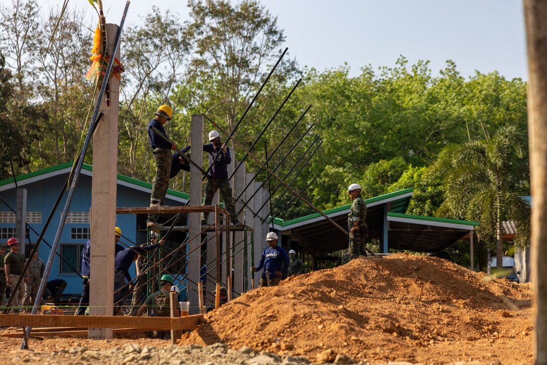 U.S. Marines with Marine Wing Support Squadron (MWSS) 171, Marine Aircraft Group 12, Royal Thai marines with the Royal Thai Marine Corps Construction Company of Combat Engineers, and members of the Singapore Army with the 30th Combat Engineer Brigade install support beams at the Ban Prakaet school in Chanthaburi, Thailand, Feb. 13, 2024. Marines of MWSS-171 lent their engineering expertise to multilateral humanitarian efforts during Cobra Gold 24. Joint Exercise Cobra Gold is the largest joint exercise in mainland Asia and a concrete example of the strong alliance and strategic relationship between Thailand and the United States. This year will be the 43rd iteration of the multilateral exercise and will be held from Feb. 27 to March 8, 2024. (U.S. Marine Corps Photo by Cpl. Calah Thompson)