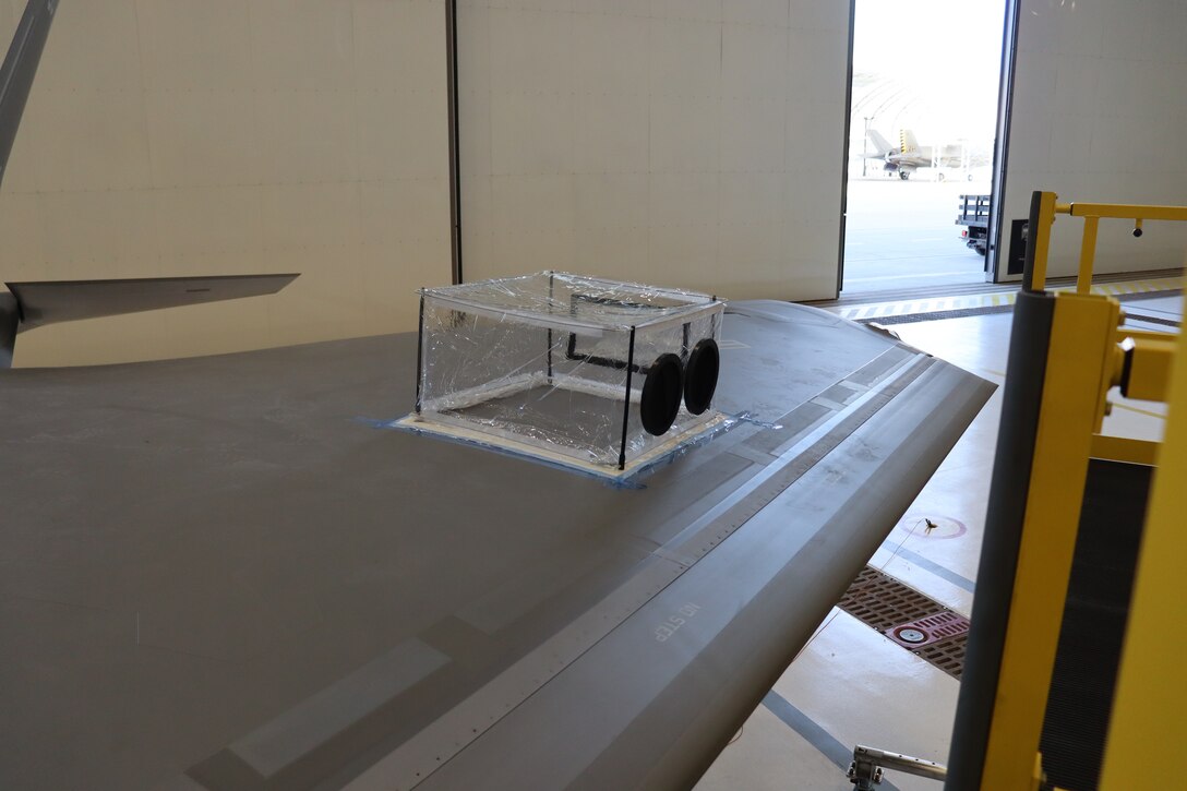 Cornerstone Research Group’s DIRT Bag DB-2424, a small 24” x 24” x 20” portable maintainer fabricated enclosure kit, or MFEK, that includes two hand ports, one hose port and one filter for routine maintenance, is set up for flightline testing on an aircraft wing at a Marine Corps Air Station facility in Dec. 2023. The DB-2424 enables debris- and dust-free structural repairs on localized areas of an aircraft and provides a controlled work environment that works the same way for every aircraft maintainer, every time. The DB-2424 is a sister product of and can be paired with the DIRT Bag DB-6090, a larger walk-in enclosure kit that is also portable, scalable and reconfigurable from 54” up to 90”. Both prototypes were developed under an Air Force Research Laboratory Small Business Innovation Research program. (U.S. Air Force photo)