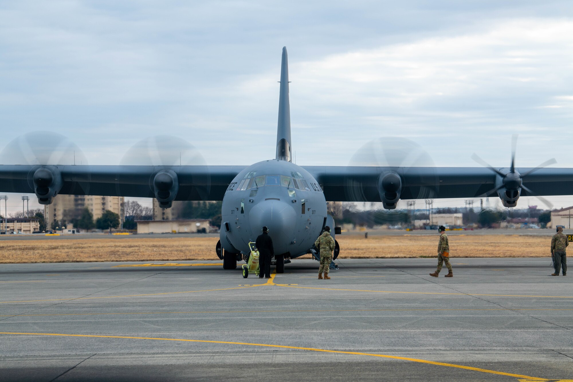 Members of the 374th Aircraft Maintenance Squadron (AMXS) prepare a C-130J Super Hercules assigned to the 36th Airlift Squadron for take-off.