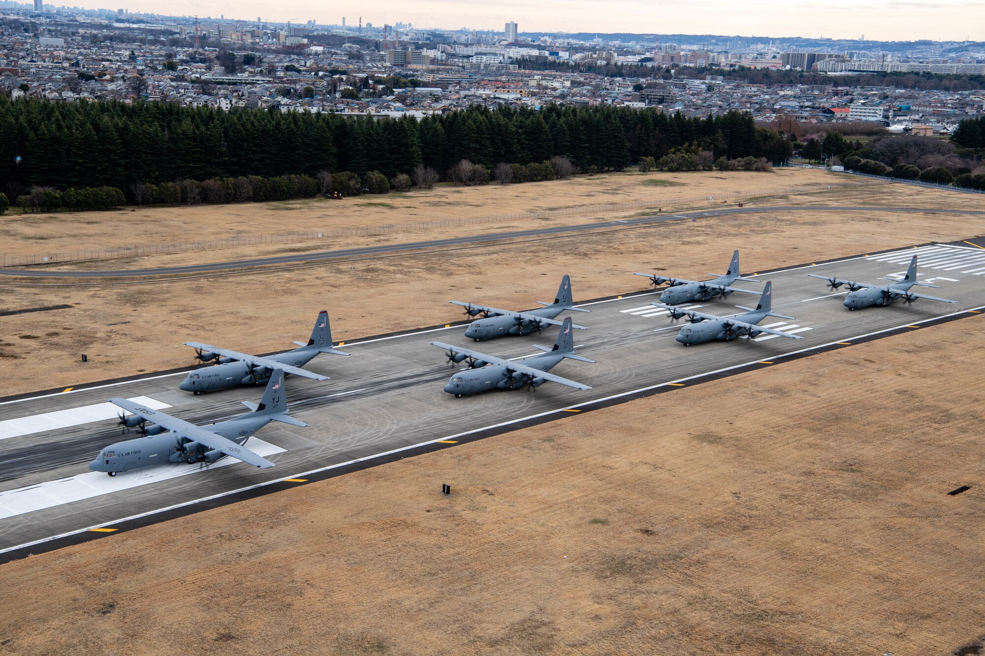 Seven U.S. Air Force C-130J Super Hercules aircraft assigned to the 36th Airlift Squadron participate in an elephant walk