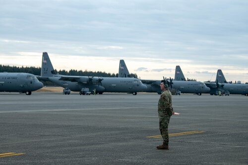 U.S. Air Force Senior Airman Giovanni Elias, 374th Aircraft Maintenance Squadron flight crew chief, waits to marshal a C-130J Super Hercules assigned.