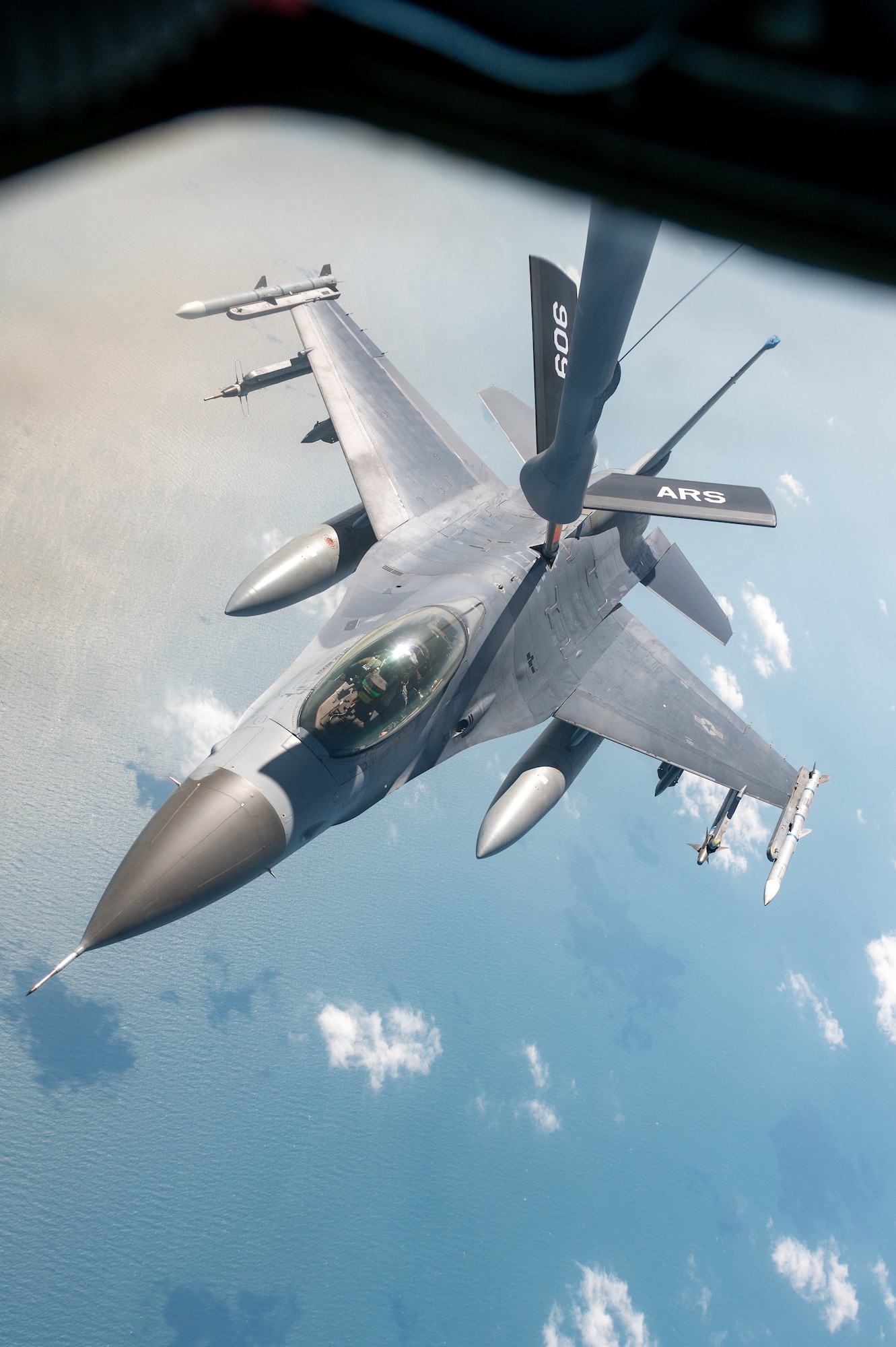 An f-16 recieves fuel from a KC-135