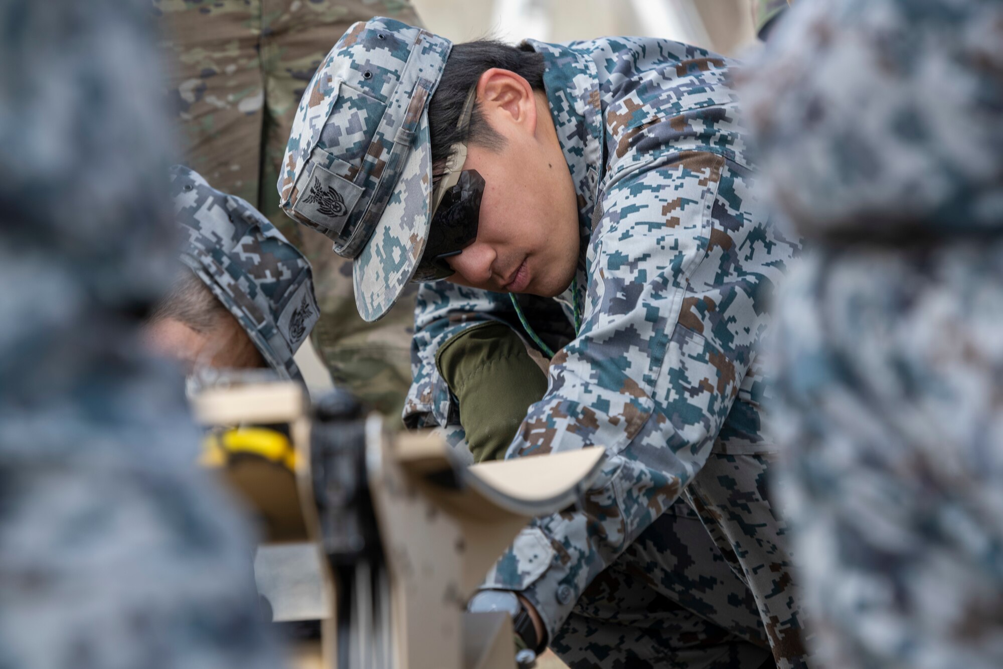 Japan Air Self-Defense Force (JASDF) Airmen assemble communication equipment during the capstone event of a Multi-Capable Airman course at Misawa Air Base, Japan, March 8, 2024.