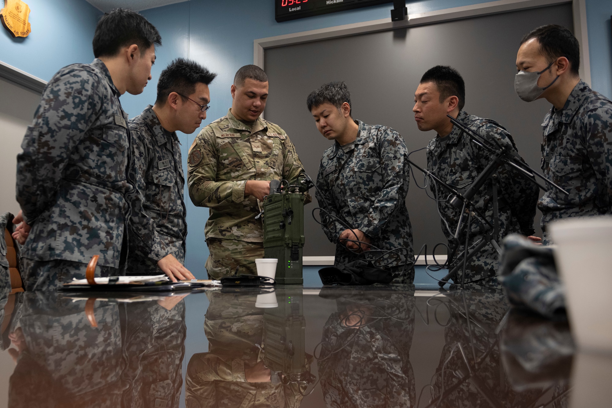 U.S. Air Force Senior Airman Kendrick Mercer, 35th Communications Squadron radio frequency transmission technician,  demonstrates communications equipment usage for Japan Air Self-Defense (JASDF) Airmen during a Multi-Capable Airman (MCA) course at Misawa Air Base, Japan, March 5, 2024.