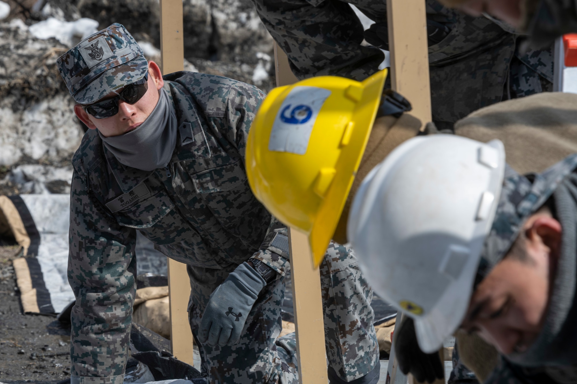 Japan Air Self-Defense Force (JASDF) and U.S. Air Force Airmen assemble a Small Shelter System during the capstone event of a Multi-Capable Airman (MCA) course at Misawa Air Base, Japan, March 8, 2024.
