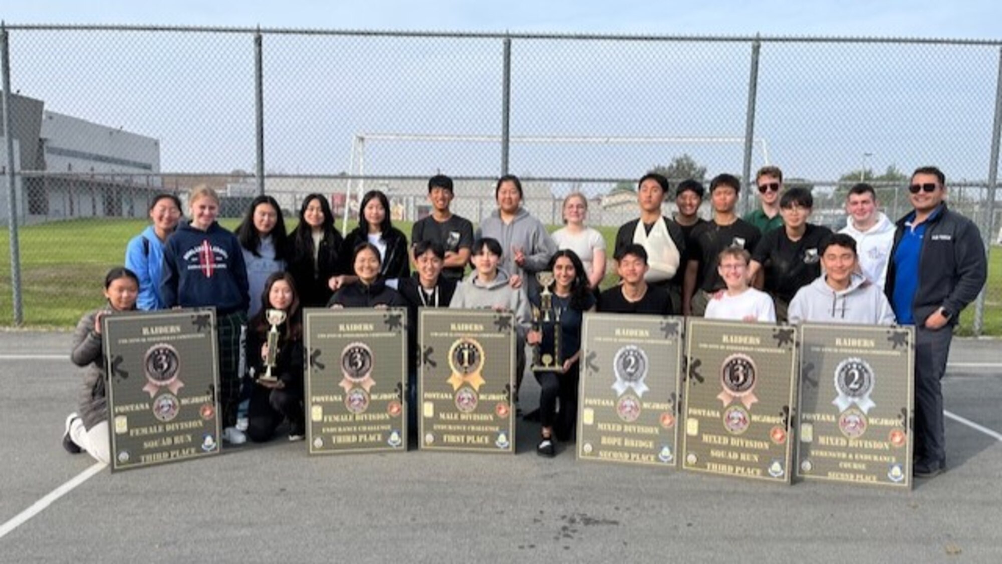 Retired Technical Sgt. Mariano Morua, right, poses with Crescenta Valley High School Air Force Junior ROTC cadets.