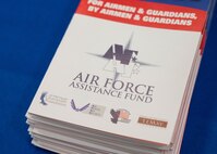 A brochure is displayed at the kickoff event for the 2024 Air Force Assistance Fund campaign at Minot Air Force Base, North Dakota, March 11, 2024. The Air Force Assistance Fund is an annual effort to raise funds for Airmen in need, including active duty, retirees, reservists, guard members and their dependents. (U.S. Air Force photo by Airman 1st Class Kyle Wilson)