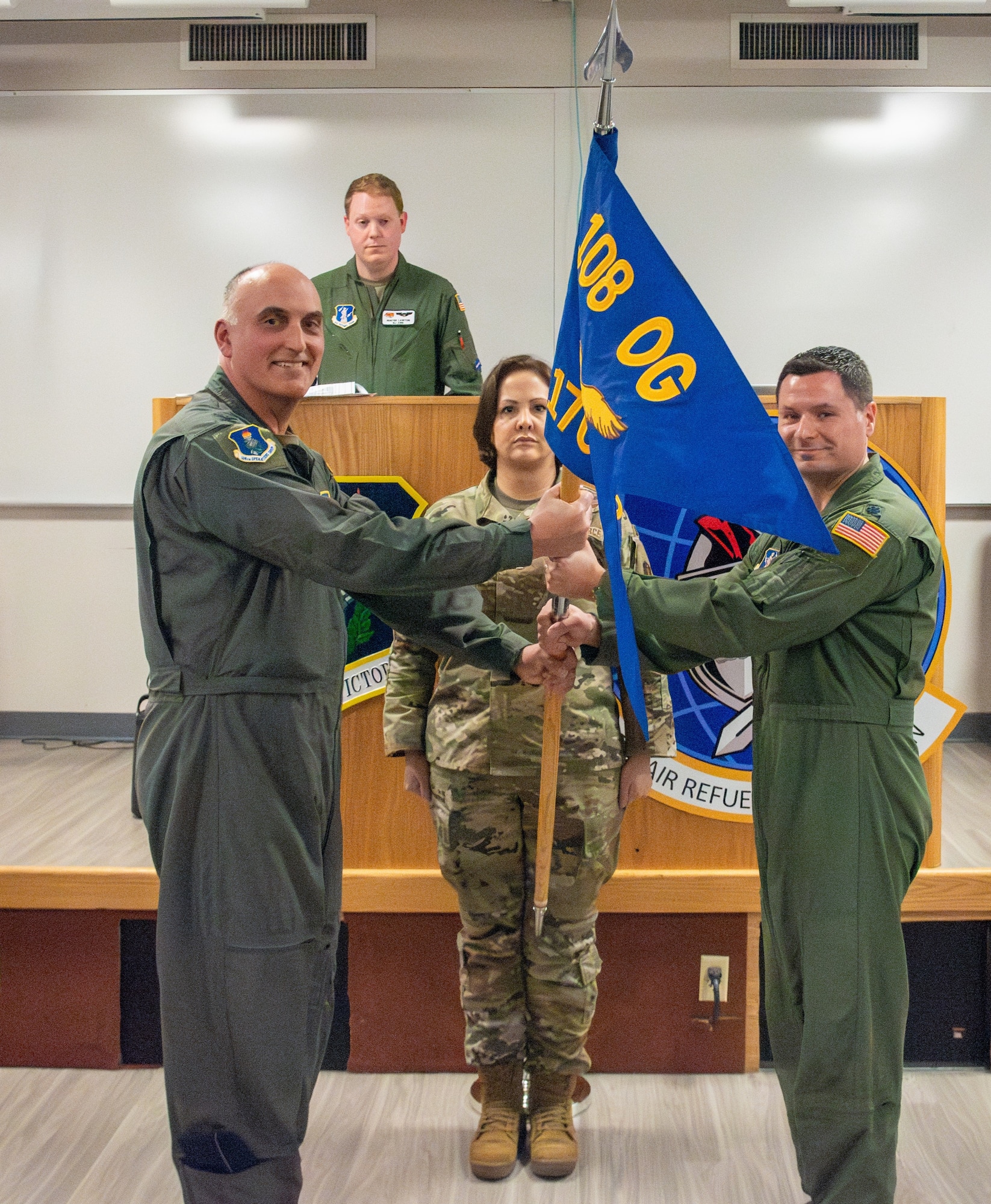 Lt. Col Matthew Secko, 170th Air Refueling Squadron commander, right, receives the unit guidon from Col. William Liess, 108th Operations Group commander, left, during the 170th assumption of command ceremony March 7, 2024, at Joint Base McGuire-Dix-Lakehurst, New Jersey. Secko is the first commander of the newly activated 170th Air Refueling Squadron.