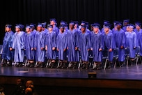 Graduates standing on stage