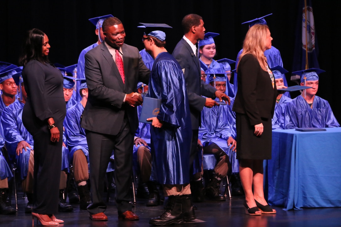 People walking across stage