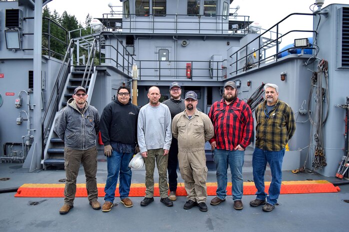 The crew of Naval Undersea Warfare Center Division, Keyport’s Yard Torpedo Test Range Craft “Battle Point” (YTT 10) pictured on deck. The marine mechanics maintaining YTT 10 have achieved “miracles” in their ongoing efforts to rejuvenate the aging vessel, according to Brian Adams, head of the command’s Undersea Test Ranges Division. (U.S. Navy photo by Anna Taylor/Released)