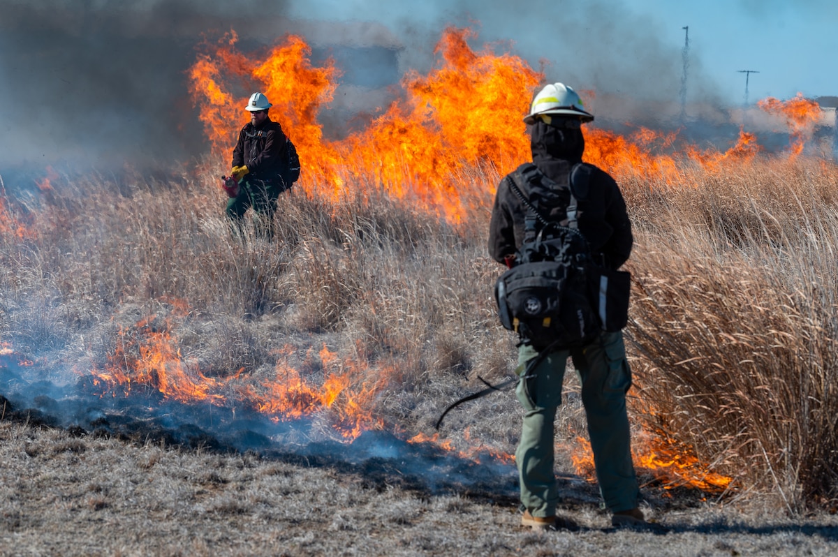 The 22nd Civil Engineer Squadron conducts a prescribed fire, also known as a controlled burn, at the Restoration Prairie on McConnell Air Force Base, Kansas, March 18, 2023. Controlled burns are conducted routinely and designed to remove the threat of potential larger uncontrolled fires. (U.S. Air Force photo by Airman 1st Class Brenden Beezley)