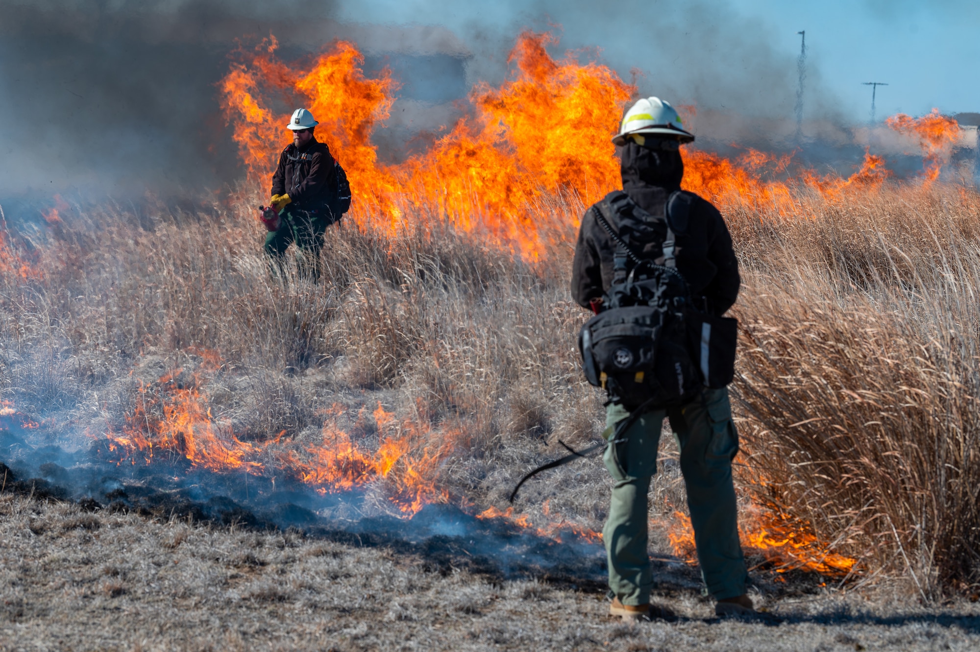The 22nd Civil Engineer Squadron conducts a prescribed fire, also known as a controlled burn, at the Restoration Prairie on McConnell Air Force Base, Kansas, March 18, 2023. Controlled burns are conducted routinely and designed to remove the threat of potential larger uncontrolled fires. (U.S. Air Force photo by Airman 1st Class Brenden Beezley)