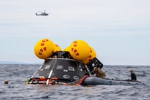 U.S. Navy Divers assigned to Explosive Ordnance Disposal Mobile Unit 1 inflate a NASA “front porch” life raft during Underway Recovery Test 11, Feb. 25, 2024.