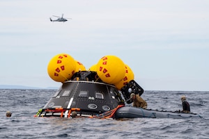 ASA astronaut candidate Chris Birch enters a crew module test article (CMTA) in the well deck aboard San Antonio-class amphibious transport dock ship USS San Diego (LPD 22) during NASA’s Underway Recovery Test 11, Feb. 24, 2024.