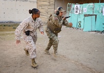 U.S. Marine Corps Staff Sgt. Dominique Craig, a combat marksmanship coach assigned to 1st Recruit Training Battalion, Marine Corps Recruit Depot San Diego, runs alongside a Jordanian Soldier assigned to the Quick Response Force Brigade during an all-female marksmanship subject matter expert exchange between U.S. Marines and Jordanian Soldiers in Zarqa, Jordan, Feb. 22, 2024. U.S. Marine Corps Forces Central Command and the Jordanian Armed Forces developed the exchange to highlight the similarities in marksmanship training and the impacts that inclusivity has within our militaries. (U.S. Marine Corps photo by Sgt. Angela Wilcox)