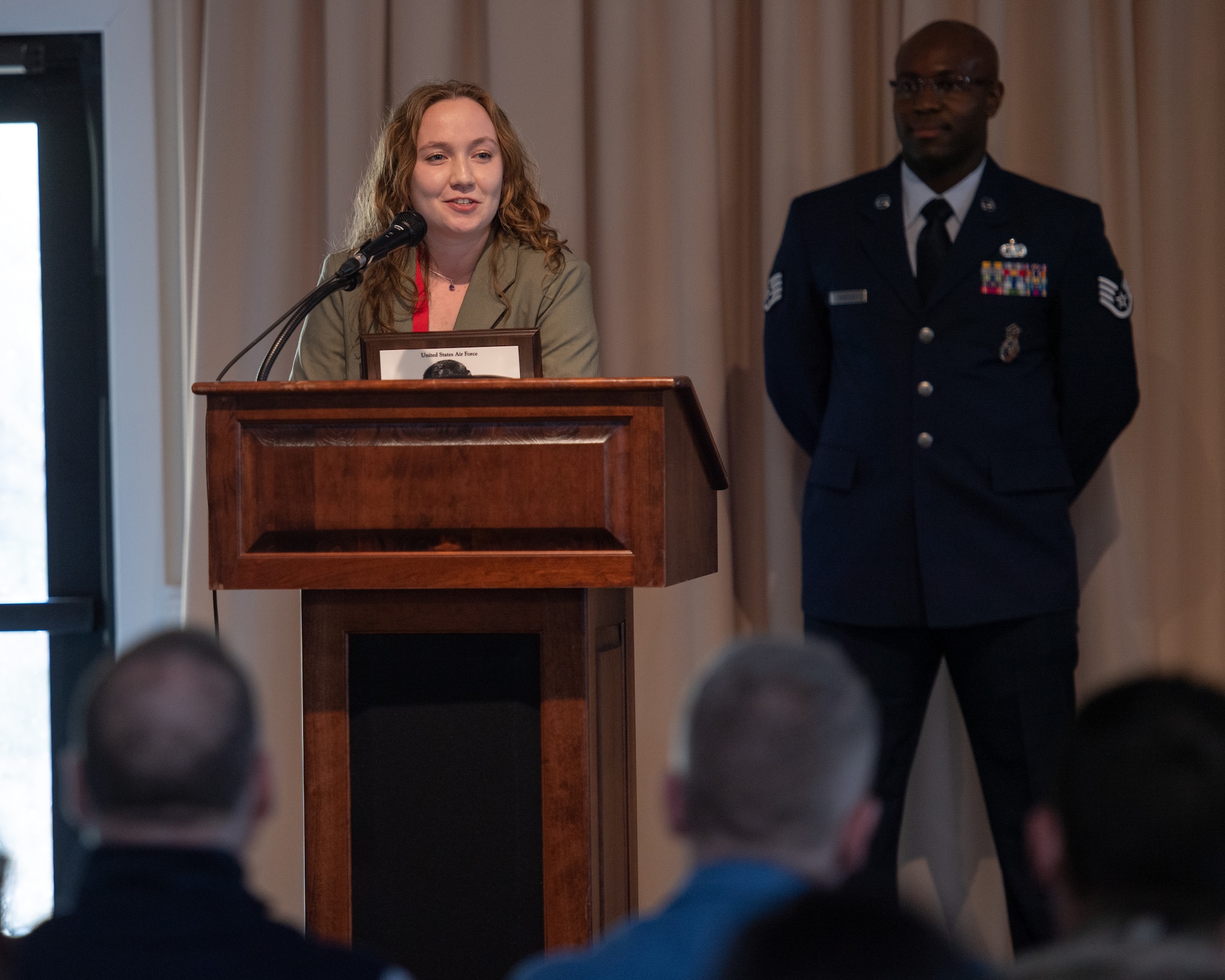 Image of civilian speaking at a podium