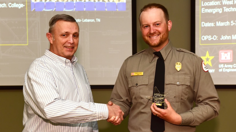 Tim Dunn, (Left) U.S. Army Corps of Engineers Nashville District Operations Division deputy chief, presents the Great Lakes and Ohio River Division Star of Life Award March 5, 2024, to Lake Cumberland Park Ranger Tanner Rich at the Nashville District's Park Ranger Workshop in Paducah, Kentucky. Rich is lauded for his response to aid a severely injured woman on the lake during the 2023 recreation season. (USACE Photo by Lee Roberts)
